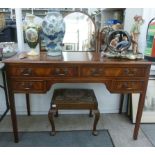 A modern mahogany finished kneehole dressing table, surmounted by a triptych mirror,