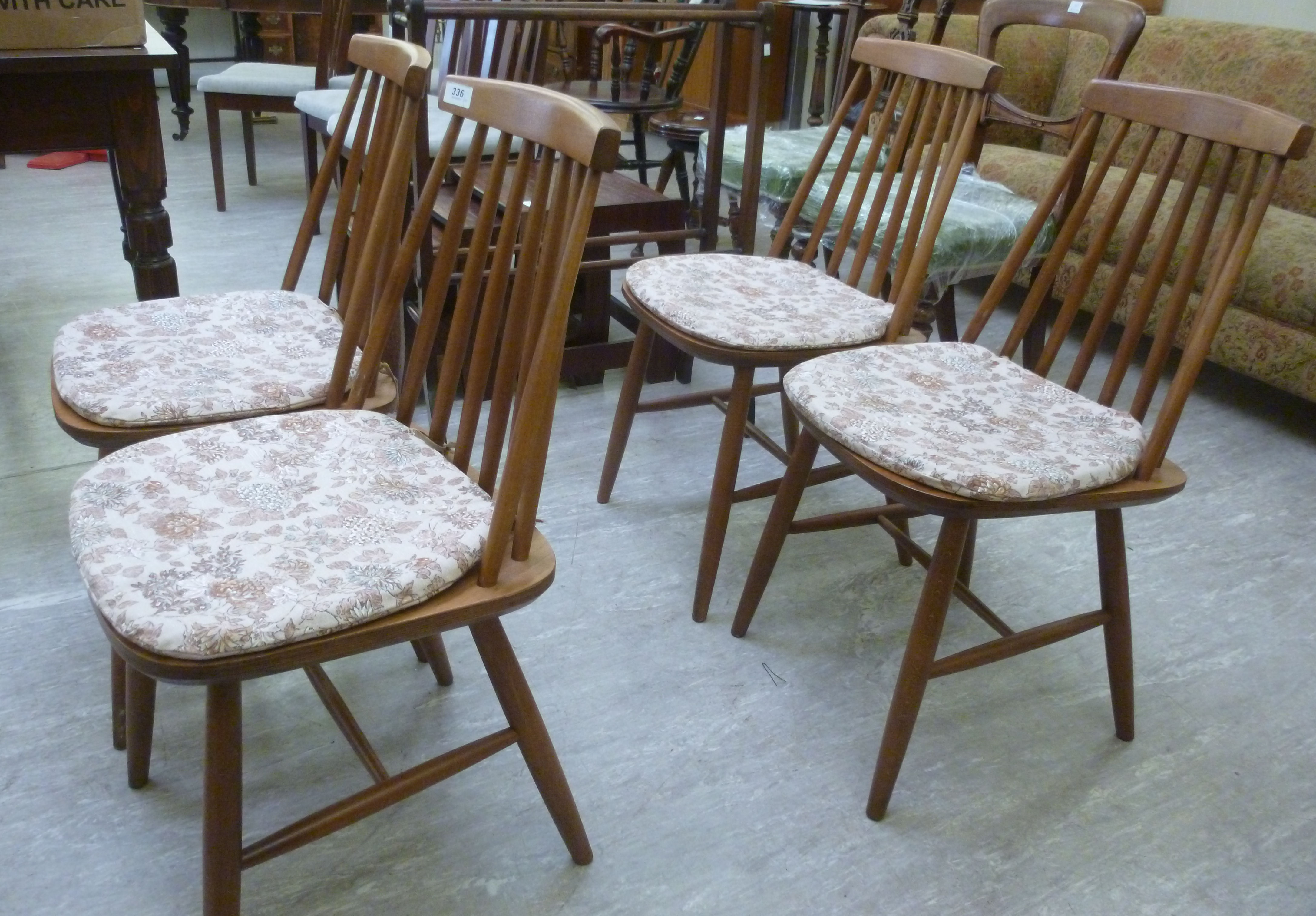 A set of four modern stained beech bar and spindle back dining chairs,