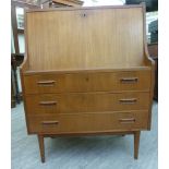 A 1970s teak finished bureau, the fall flap enclosing a fitted interior, over three long drawers,