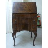 A modern reproduction of a Queen Anne style lady's mahogany finished bureau,