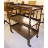 A 1920/30s stained oak three tier tea trolley,