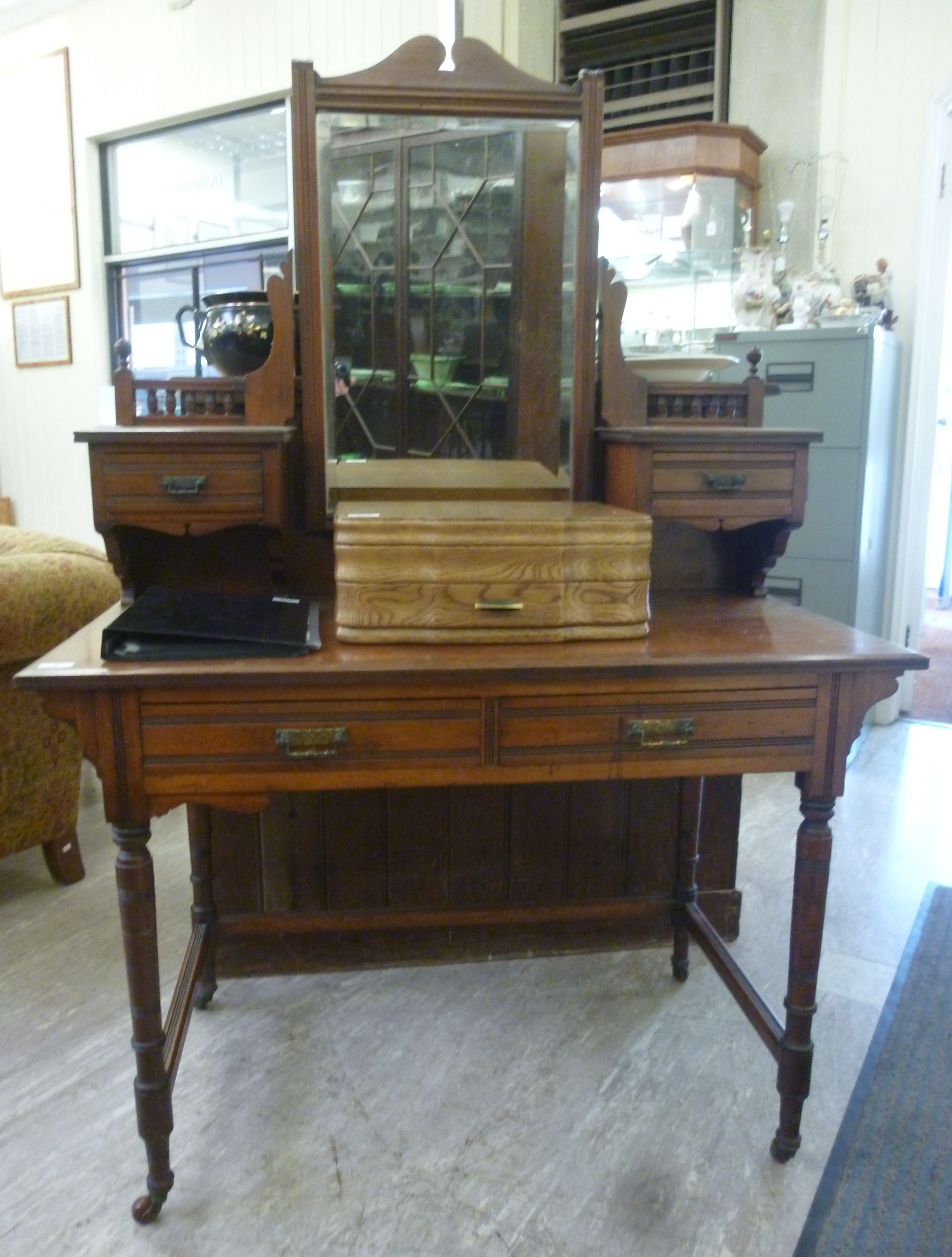 A late Victorian mahogany dressing table, the top surmounted by a mirror, over two drawers,