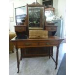 A late Victorian mahogany dressing table, the top surmounted by a mirror, over two drawers,