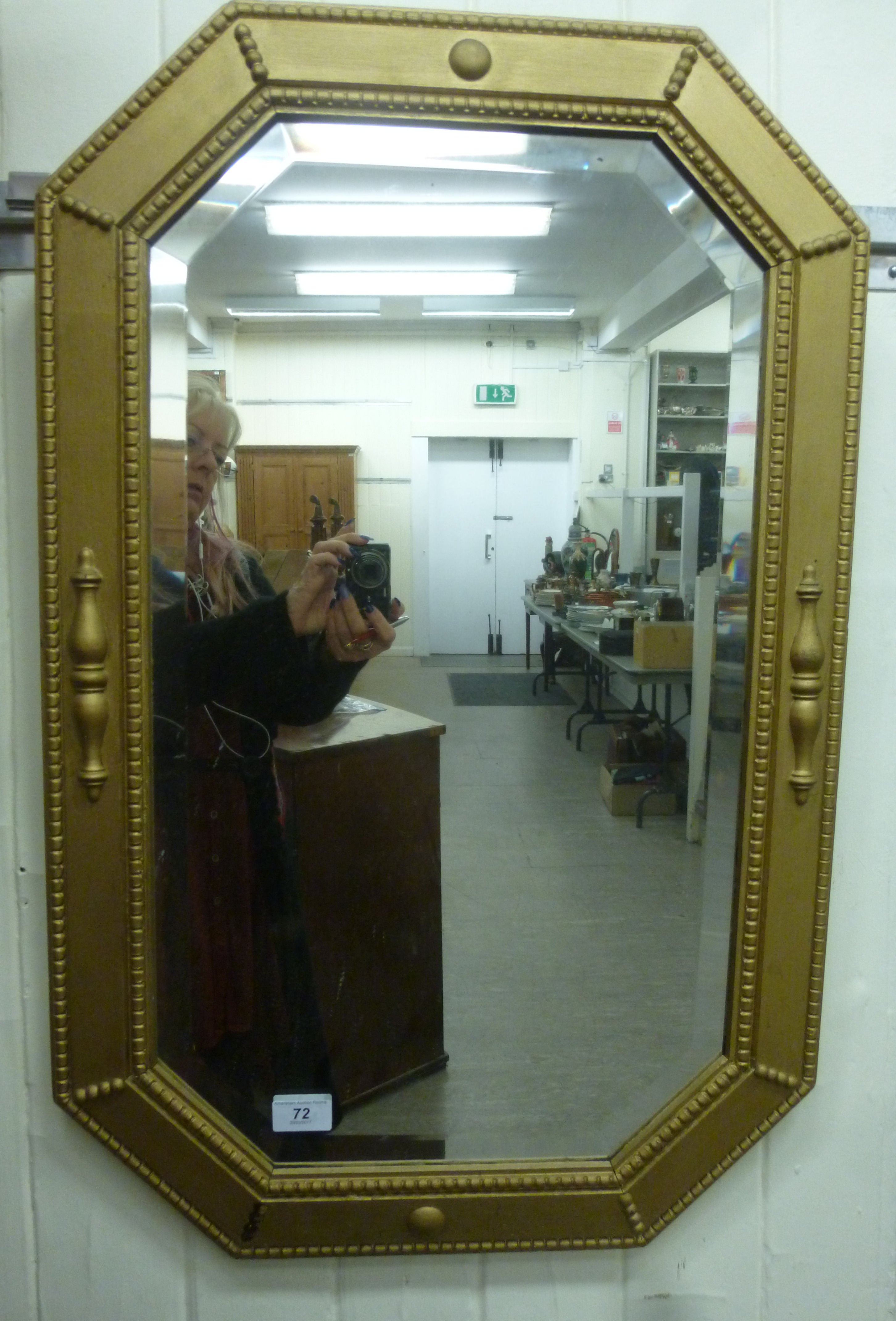 A 1920s mirror of elongated octagonal form,