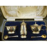 An early 20thC silver three piece condiments set Birmingham 1926 in a fabric lined,