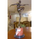 A cast bronze figure, an Art Deco style woman dancing,