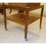 A 1970s teak and other two tier coffee table, raised on square,