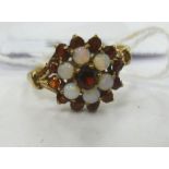 A 9ct gold opal and garnet set cluster ring 11