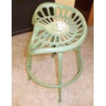 An (as new) green painted cast iron and steel stool with a height adjustable tractor style seat,