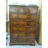 A modern mahogany finished dressing chest with two short/five long drawers,