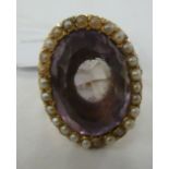 A late Victorian 9ct gold ring, set with a foiled amethyst coloured stone,