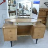 A 1950s white painted and teak finished dressing table, surmounted by a triptych mirror,