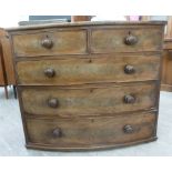 An early Victorian mahogany bow front five drawer dressing chest with bun handles,