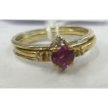 A 9ct gold claw set ruby and diamond bi-coloured ring with a detachable central band 11
