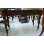 A Victorian style stained pine and mahogany hall table, the top raised on ring turned,
