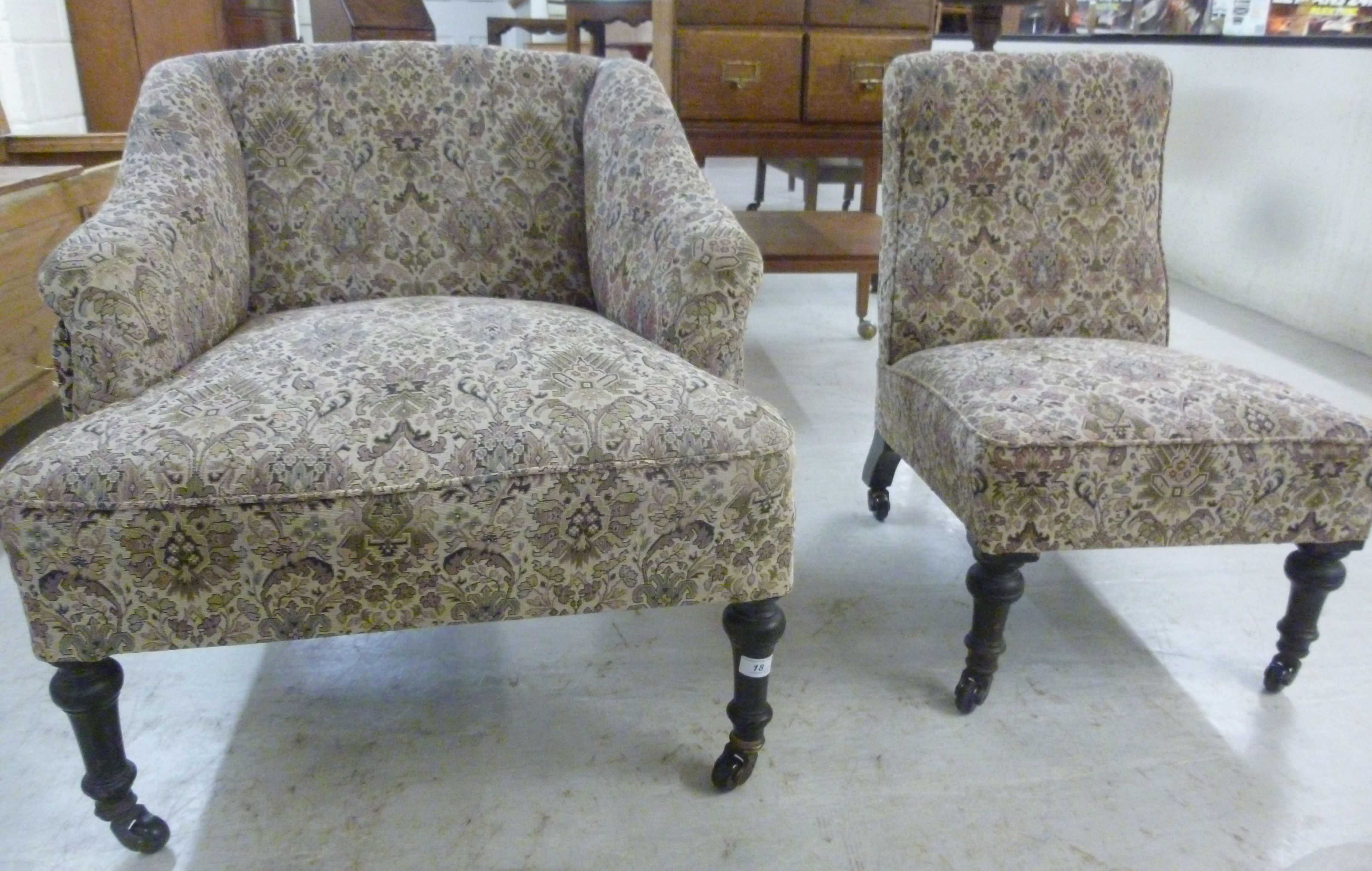 Two similar late Victorian tapestry upholstered nursing chairs, each raised on turned,