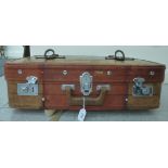 A 20thC stitched faux hide suitcase with brown hide straps bears a label 'Golden Leg' China