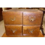 A 1920s stained oak table top, four drawer filing cabinet,