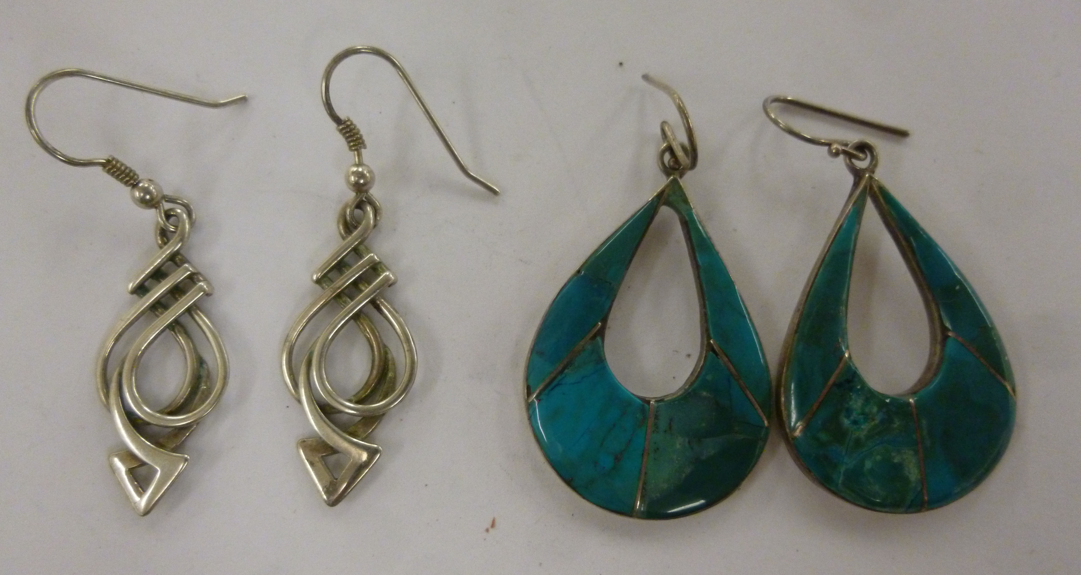 Two pairs of silver pendant earrings,