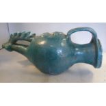 An 'antique' Middle Eastern turquoise glazed earthenware pouring vessel of bulbous form with a