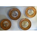 Four Prattware pot lids, in turned oak frames, viz.