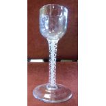 A 19thC wine glass, the cup shaped bowl with muted, vertically ribbed ornament,