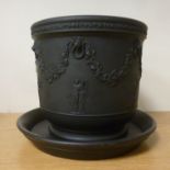 A Wedgwood black basalt vase with straight sides, on a splayed footrim,