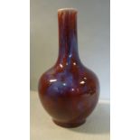 A mid 20thC Chinese sang de boeuf porcelain bottle vase with a long, narrow neck 9.