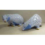 A pair of Herend porcelain model badgers, decorated in blue and white designs,