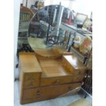 An Art Deco satin mahogany dressing table, surmounted by a substantial circular bevelled mirror,