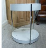 A 1960s white enamelled two tier floorstanding shelf unit with section tubular chromium plated