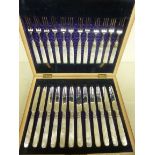 A set of twelve engraved silver plated dessert knives and forks,