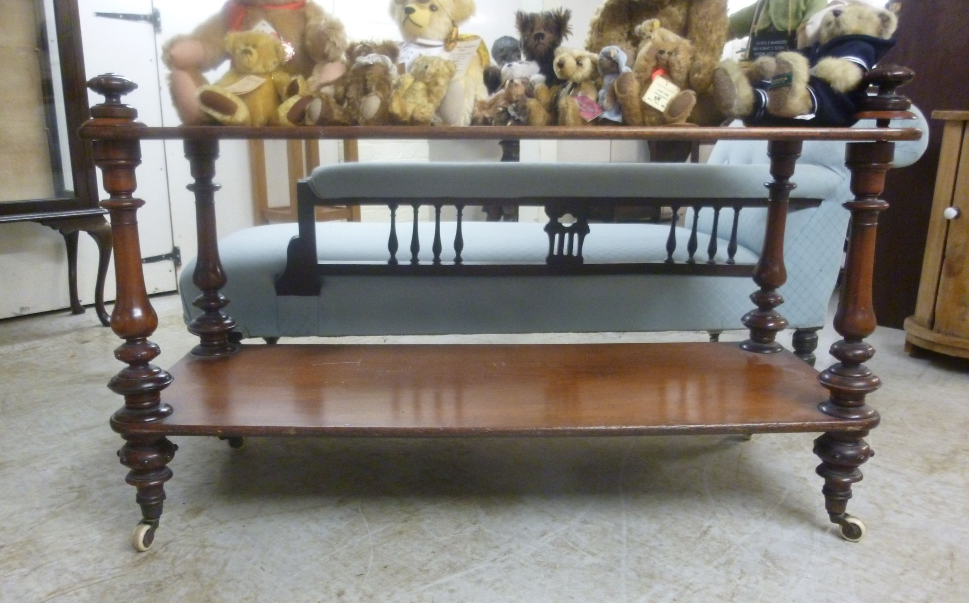 An early Victorian mahogany low buffet with four knopped, turned, tapered, baluster pillars,