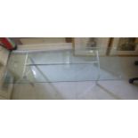 A 1960s coffee table with a clear plate glass top,