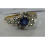 An 18ct gold claw set sapphire and diamond ring 11