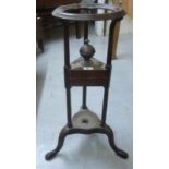 An early/mid 19thC mahogany shaving stand of triform design with a bowl aperture,