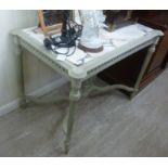 A Continental 'antique' finished washed pale green painted and carved pine centre table,