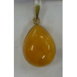 A Russian gold coloured metal framed and amber set pear shaped pendant 11