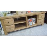 A modern light oak side cabinet, having a panelled, dowelled top, over a divided, open,