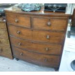 An early 19thC mahogany bow front dressing chest with two short/three long drawers, raised on squat,