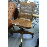 A modern light stained oak framed desk chair,