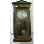 A late 19th/early 20thC Vienna style ebonised and polished walnut cased wall clock with gilt metal