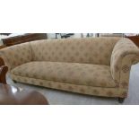 A modern Chesterfield style settee, upholstered in patterned, old gold coloured tapestry fabric,