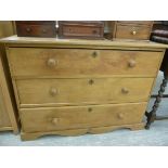 An early 20thC waxed pine dressing chest, the three long drawers with bun handles,