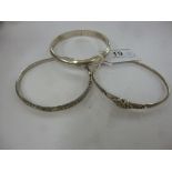 Three dissimilar silver bangles 11