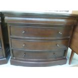 A modern mahogany finished bow front dressing chest with a cushion moulded frieze drawer,