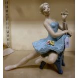 A Spanish porcelain figure, a seated ballerina,