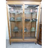 An early 20thC fully glazed, light oak trophy cabinet with a straight, moulded cornice,