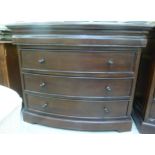 A modern mahogany finished bow front dressing chest with a cushion moulded frieze drawer,