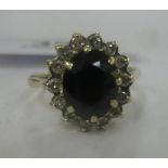 A 9ct gold claw set sapphire and diamond cluster ring 11